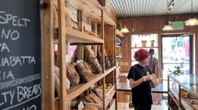  An Athens Bread Company employee packages up pastries for customers on a sunny afternoon.
