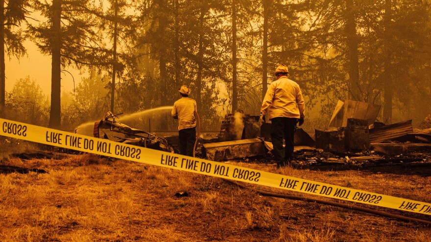 Firefighters try to control the Santiam Fire in Mill City, Ore., on Thursday. About 500,000 people have been evacuated in the state as fires ravage some 900,000 acres.