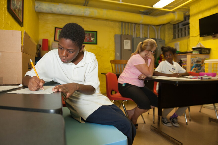 A boy does his homework at one of the Bethany House shelters.