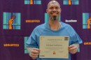 Michael Callahan holds up a certificate at the Uncuffed San Quentin 2025 Graduation
