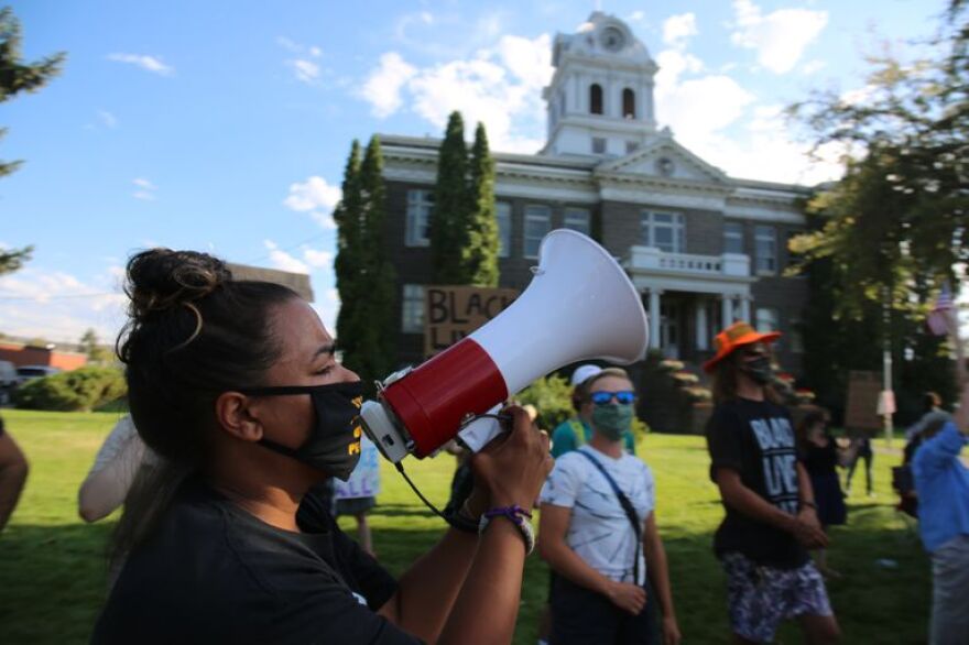 Josie Stanfield leads a chant outside the Crook County courthouse on August 15, 2020.