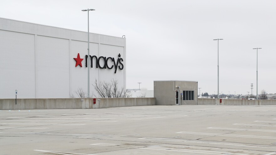 An empty parking lot surrounds the Macy's at the Roosevelt Field Mall on March 20 in East Garden City, N.Y. The retail chain had previously announced plans to close about 125 stores over the next three years. [Al Bello / Getty Images]