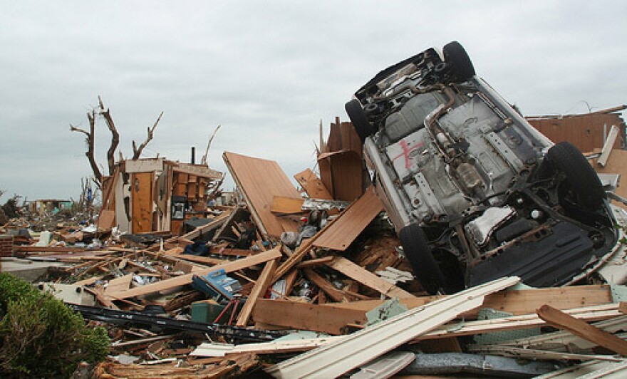 A overturned car sits where a house once stood in Joplin, Mo. on May 24. Mo. Gov. Jay Nixon has announced that the federal government will pay 90 percent of costs associated with expedited debris removal from Joplin.