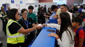 Passengers check in at Simon Bolivar International Airport as it reopens to commercial flights two months after closing due to the earthquake in Maiquetia, Venezuela, Tuesday, Sept. 1, 2026.