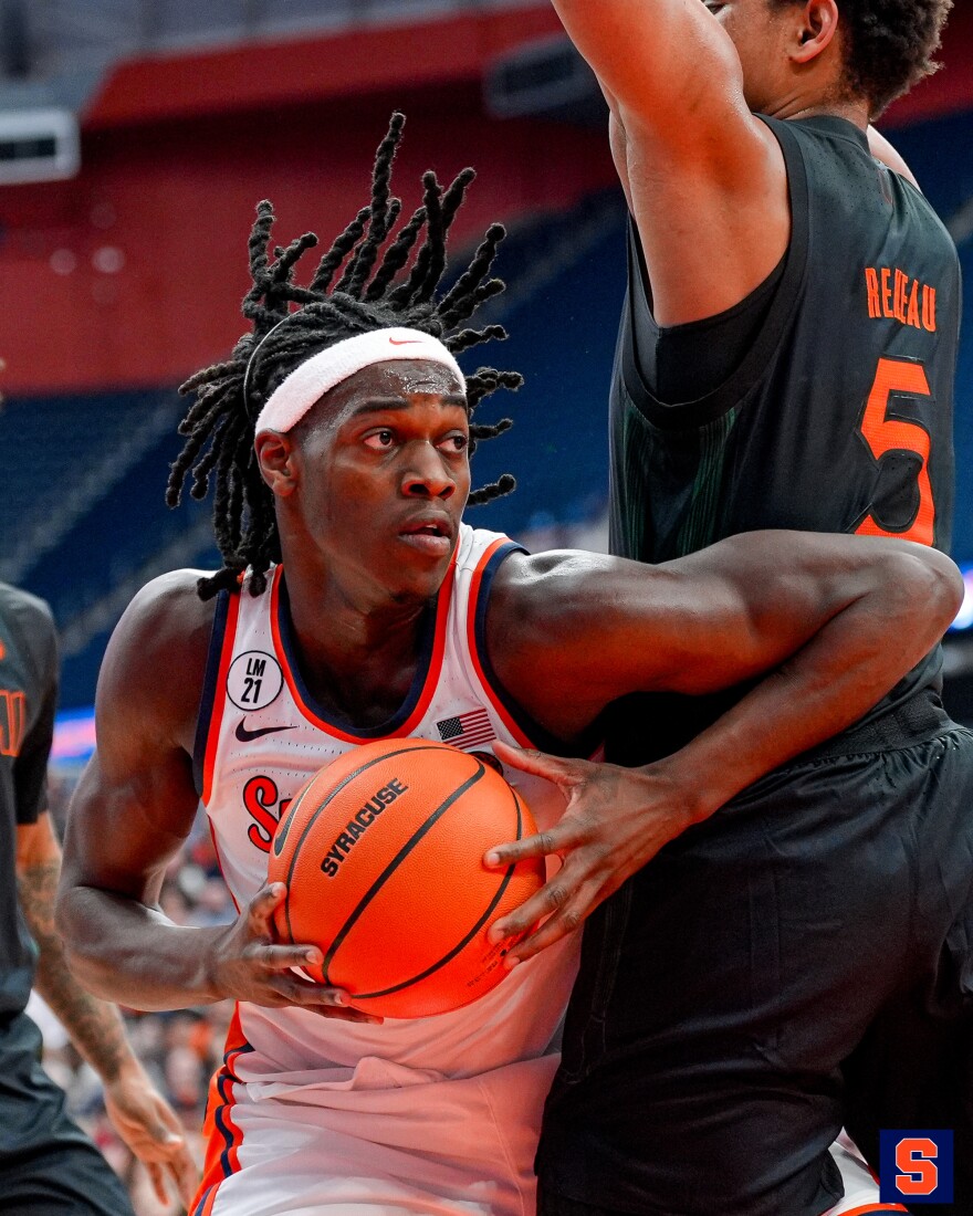 Syracuse forward William Kyle (42, White) navigates around a defender
