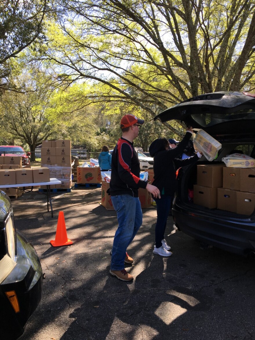 Second Harvest of the Big Bend loaded boxes of food into the hundreds of vehicles that lined up for the distribution