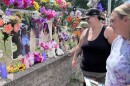 Chantel Smith, right, smiles at a photo of her daughter Lexi Thornton. Former neighbors Simone Aune and her son Landon Gorton were reminiscing July 17, 2026, outside Smith's Brainerd home. A memorial continues to grow in honor of 13-year-old Lexi, who died by suicide on July 10.