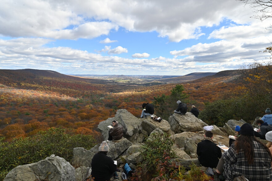 University of Pennsylvania landscape architecture students paint at the edge of the south lookout at Hawk Mountain Sanctuary in November 2025.