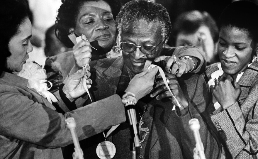 In 1986, South African activist, Nobel Peace Prize recipient and Anglican Archbishop Desmond Tutu receives the Martin Luther King Jr. Award for Non-Violence for his commitment and role during the struggle against apartheid, from Coretta Scott King (left), her daughter Christine King Farris (rear) and Tutu's daughter Nontombi Naomi Tutu.