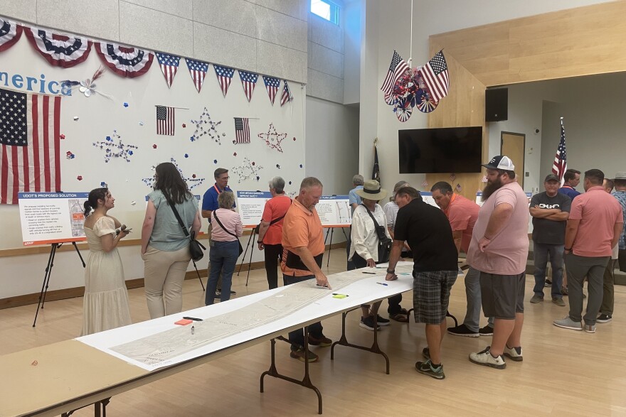 Attendees at the UDOT open house July 17 asked questions about the barrier plans and scribbled comments on a large map of U.S. 40 spread across several tables.