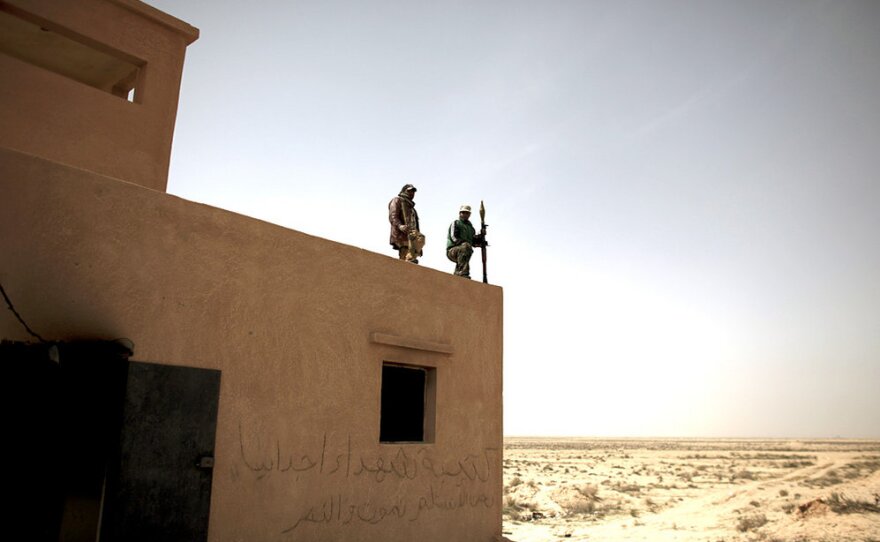 Defected Libyan soldiers stand guard outside an army base in the eastern town of Ajdabiya, Libya, on Tuesday. Eastern cities are free from government control, but fighting continues around the capital Tripoli, controlled by Libyan leader Moammar Gadhafi.