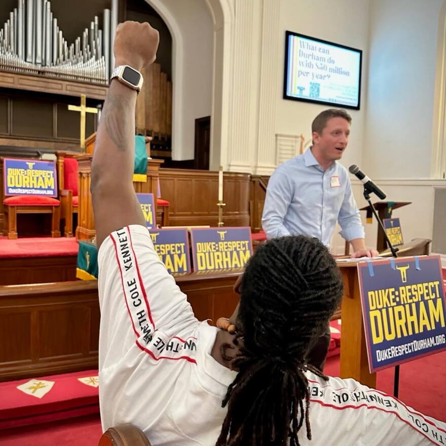 Durham City Council Member Nate Baker speaks at a Duke: Respect Durham event in September 2024