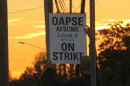 A Princeton bus driver holds an "On Strike" sign outside of First Student's bus garage in Sharonville.