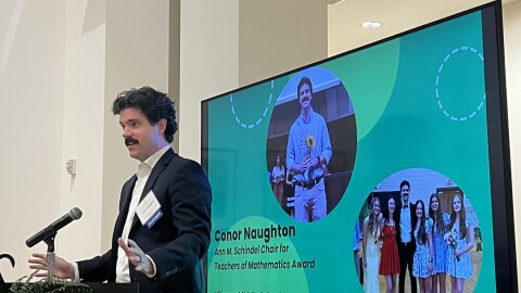 a man gives a speech standing at a podium