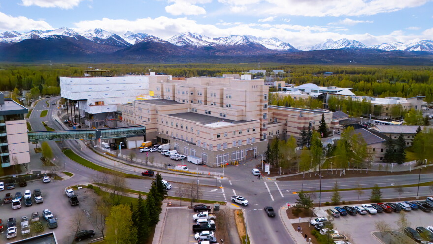 An aerial view of a hospital building and surrounding parking lots.