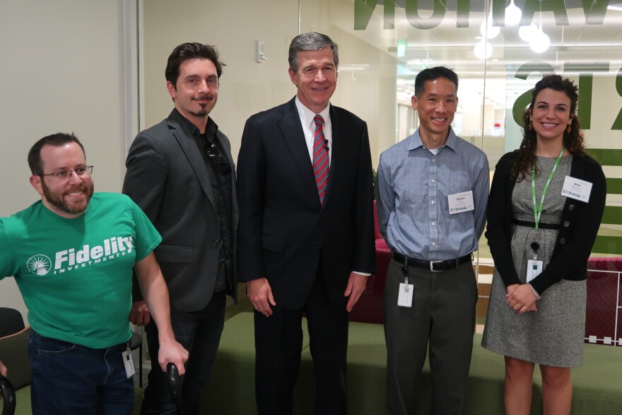 Gov. Roy Cooper congratulates the creative team that developed the Navigator. From left to right, Christian Felkl of Fidelity Investments, Mark Branly of Registered Creative, Cooper, Stuart Shih and Alex Mussorici of Fidelity Investments.