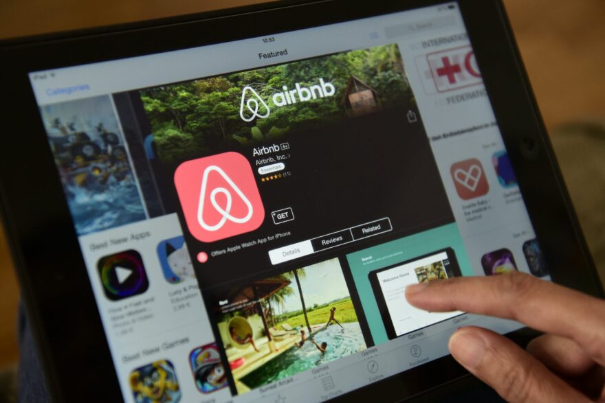 A woman browses the site of US home sharing giant Airbnb on a tablet.