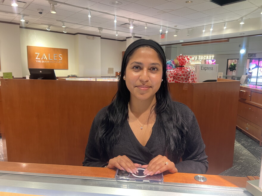 Jahaira Pacheco, a Gateway Community College Student, stands in her workplace in Connecticut Post Mall in Milford.