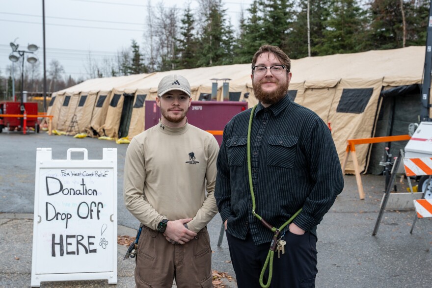Anchorage Animal Care and Control Assistant Shelter Manager Logan Robinson, left, and Community Outreach Manager Joel Jorgensen stand outside a temporary emergency shelter set up for dogs arriving from Western Alaska on Oct. 23, 2025.