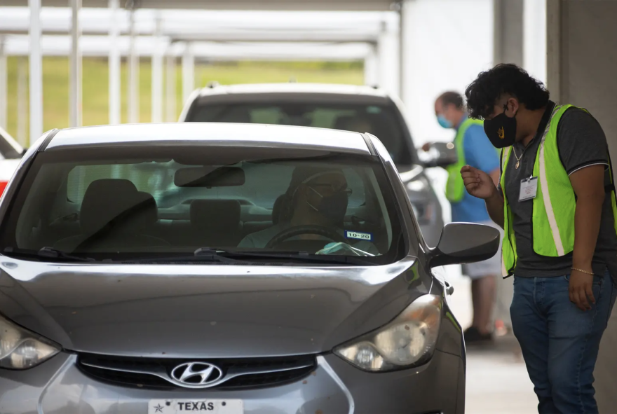 Drivers line up to cast ballots at NRG Stadium in Houston on the first day of early voting. Republican activists say the drive-thru polling site is unconstitutional. 