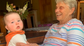 woman holds a baby on her lap