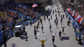 Runners approach the finish line during the 118th running of the Boston Marathon on Monday. A number of the world's top runners were in the field amid heavy security one year after a deadly terrorist bombing.