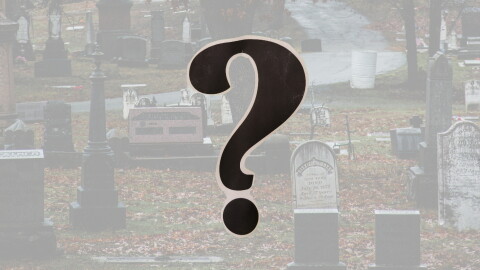 Cemetery with a question mark in the foreground
