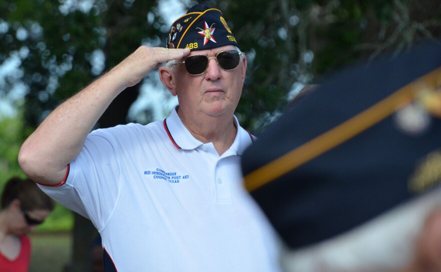 Post 483 Commander Gary Thompson led the services before placing flags on headstones.