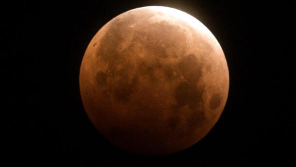 The total lunar eclipse is seen over Santa Monica Beach in Santa Monica, Calif., Wednesday, May 26, 2021. (Ringo H.W. Chiu/AP)