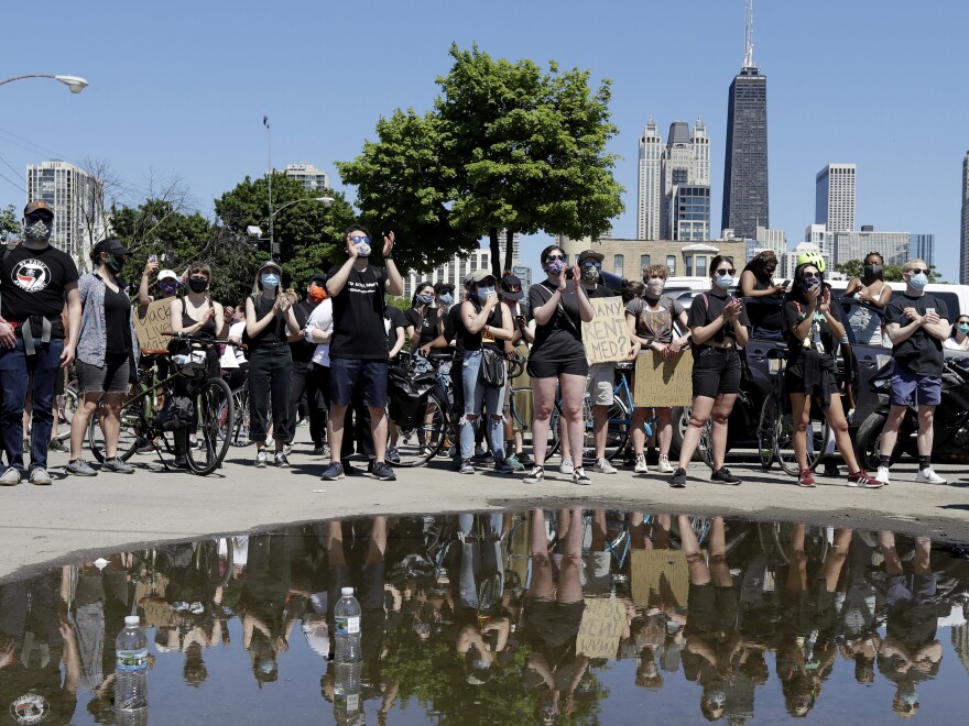 Demonstrators listen to a speech during the Chicago March for Justice in honor of George Floyd in Chicago Saturday.