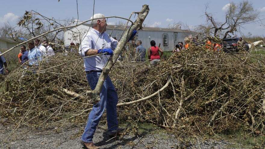 Vice President Pence helps clear brush during a visit to Texas on Thursday.