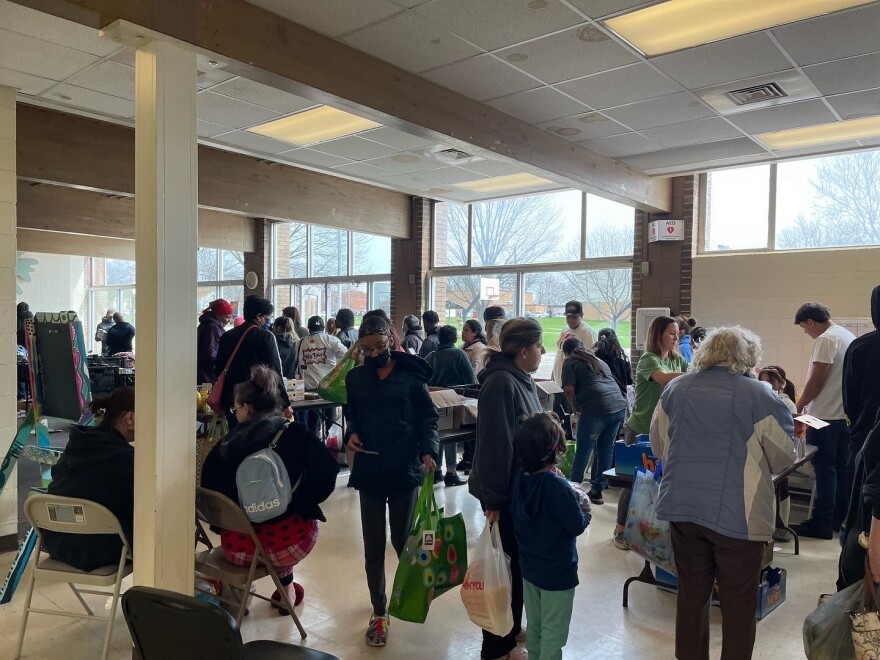 Community members giving and receiving food at the Market 309 Logan Recreation Center location