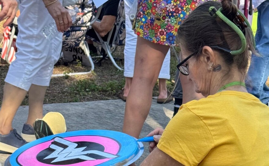 Stacey Snyder of North Fort Myers was painting a Wonder Woman shield at the protest in Fort Myers.