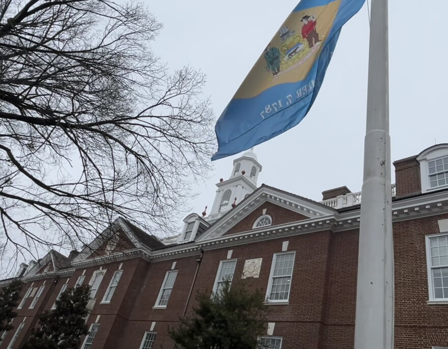 Delaware's state flag and capital building in Dover.