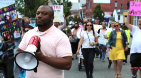 Anthony Harden's brother, Carl Harden, leads a crowd of protesters down South Main Street in Fall River in June 2022.