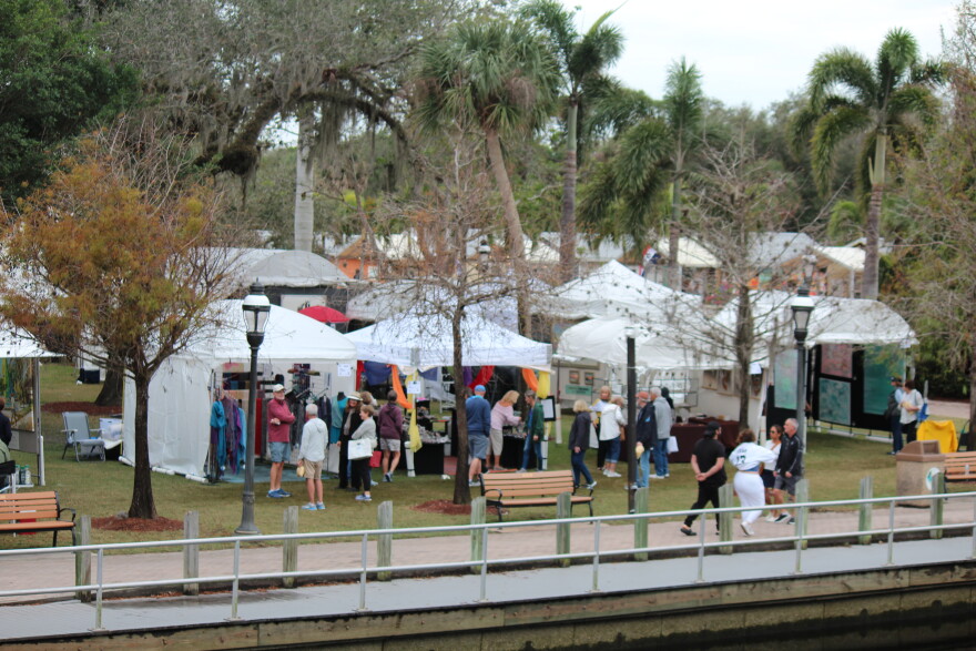Outdoor fine art festival in Bonita Springs with artists' tents and visitors