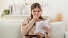 Asian woman feeling unhappy after looking at the bill feels stressed having financial problem, check finances, experiencing lack of money pay for loan, huge taxes, utility rates, get eviction notice, bank debt notification