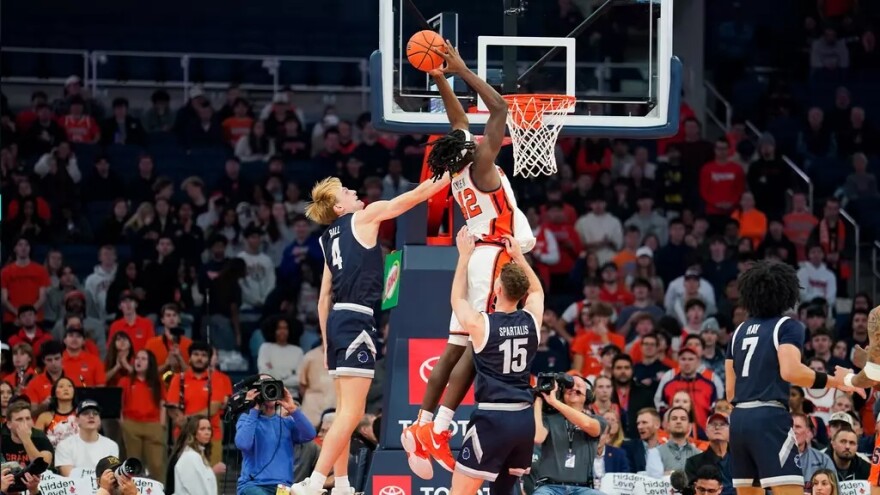 Center William Kyle (42, White) slams down a dunk against Monmouth