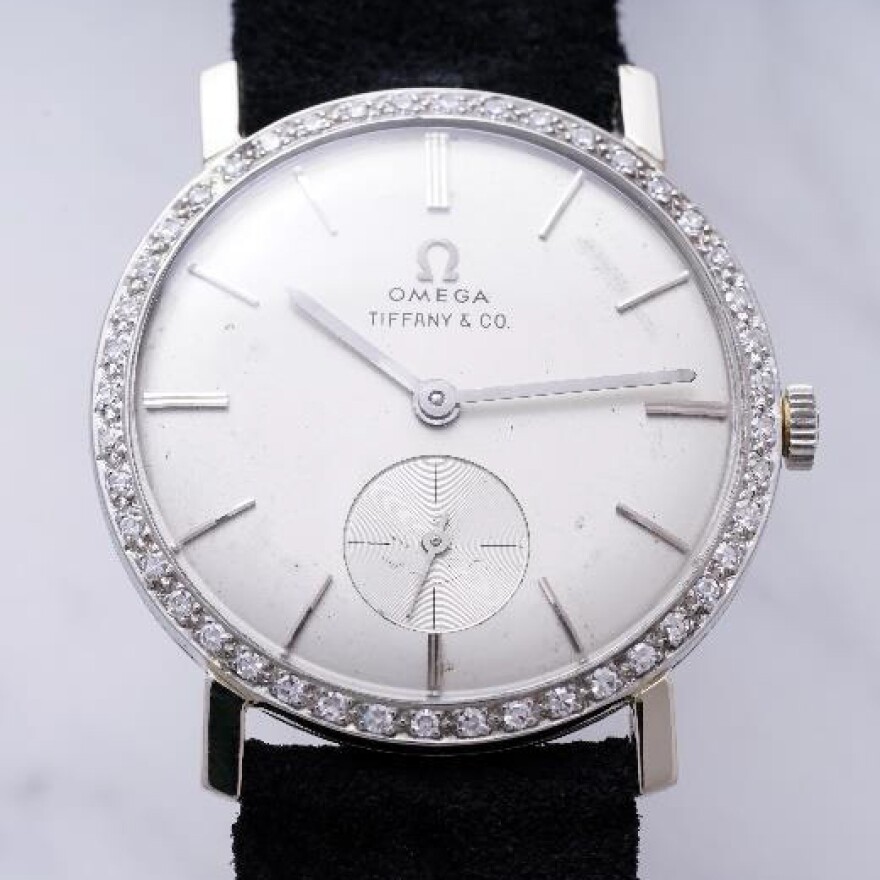 The watch features an 18k white gold case with forty-four diamonds encircling the face.