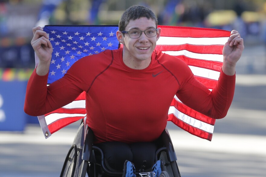 Daniel Romanchuk of the United States poses for a picture after crossing the finish line first in the men's wheelchair division.
