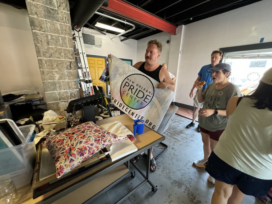 Kyle DeVries, board president of the New Orleans Pride Center, holds a sign inside the organization's new space in Mid-City. The new LGBT-focused community center will open its doors on April 6.