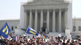 One of the attorneys in the California Proposition 8 case, David Boies (center), speaks outside the Supreme Court as he's surrounded by plaintiffs in the case, couples Paul Katami (from left) and Jeff Zarrillo, and Sandy Stier and Kris Perry.