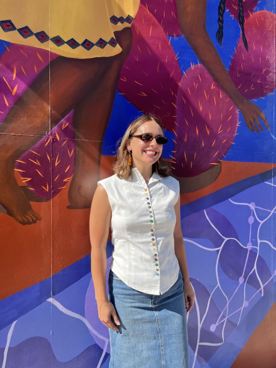 Co-lead artist Hailey Marmolejo stands in front of the newly dedicated mural at Market Square