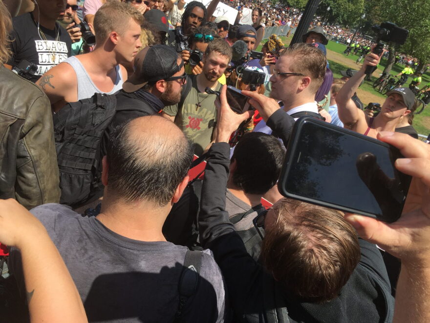Counter-protesters surround a man who was trying to approach the Parkman Bandstand in Boston, on Aug. 19, 2017.