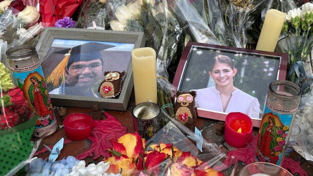 Flowers and candles surround photos of Mukhammad Aziz Umurzokov, an 18-year-old freshman from Brandermill, Va., and Ella Cook, a 19-year-old sophomore from a suburb of Birmingham, Ala., in front of a Brown University gate in Providence, R.I., on Wednesday, Dec. 17, 2025. (AP Photo/Leah Willingham)