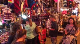 Visitors peruse the items vendors have on display in this file photo from the 2017 Cristo Rey Fiesta.