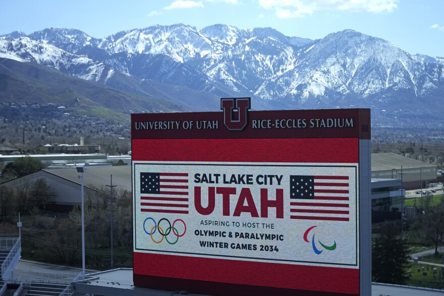 FILE - The scoreboard at the University of Utah's Rice-Eccles Stadium promotes Salt Lake City's bid to host another Winter Olympics in 2034 as International Olympic Committee members prepare to tour the stadium and other venues on April 10, 2024, in Salt Lake City. On June 10, 2024, organizers of the Salt Lake City Olympic committee revealed the estimated budget for hosting the 2034 Winter Olympics.
