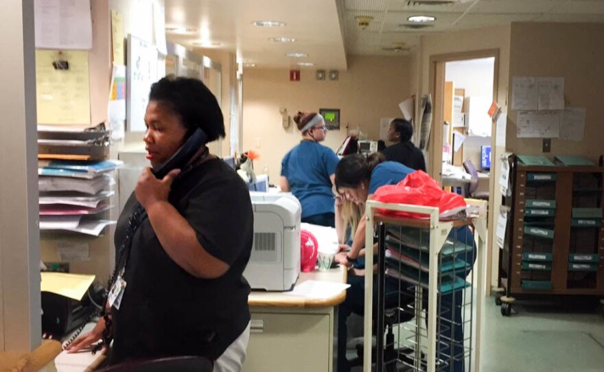Nurses at the telemetry unit of Trinity Hospital respond to patient calls and monitor patient vital signs.