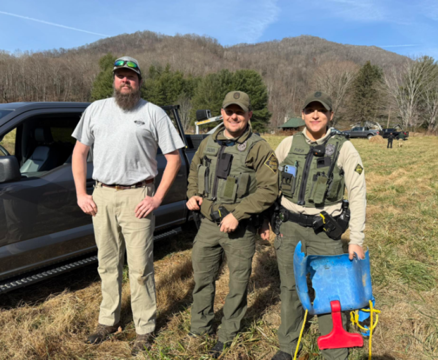 District 9 wildlife biologist Justin McVey is on the left after helping remove the swing from the elk’s antlers.
