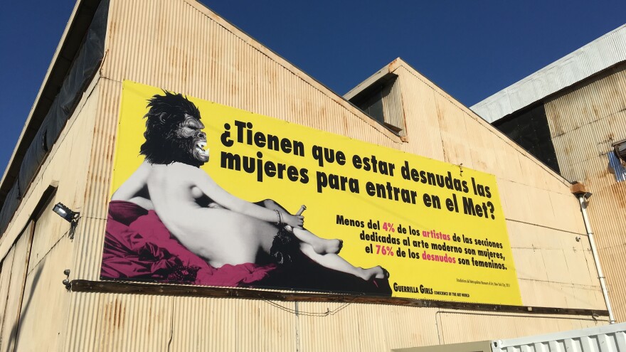 "Beyond the Streets" boasts one of the Guerrilla Girls' most well-known billboards — in Spanish. It translates to "Do women have to be naked to get into the Met? Less than 4 percent of the artists in the modern art sections are women, but 76 percent of the nudes are female."